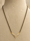 Gold-plated double V CZ mangalsutra displayed on a cream jewellery bust, showing full black bead chain