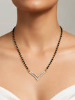 Gold-plated CZ double chevron mangalsutra worn on a model's neck over a white top
