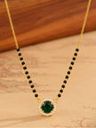 Close-up of green cubic zirconia mangalsutra pendant with white CZ halo and black bead chain on warm background
