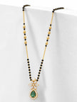 Side-angle view of gold-plated mangalsutra with black beads and emerald CZ pendant against white background