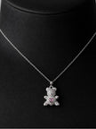 Silver-tone pavé CZ teddy bear pendant necklace displayed on a black jewellery bust