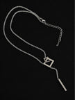 Full silver lariat necklace laid flat showing lobster clasp, extender chain, interlocked square pendant and bar drop