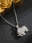 Close-up of pavé cubic zirconia elephant pendant with golden rose prop in background