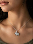 Woman wearing silver cubic zirconia elephant pendant necklace on bare neckline