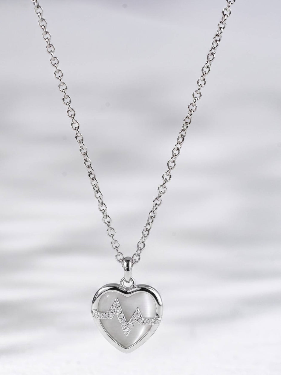 Full length silver cable chain with heart heartbeat pendant hanging centred on white background