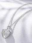 Close-up side angle of heart pendant showing cubic zirconia heartbeat motif and opalite inlay