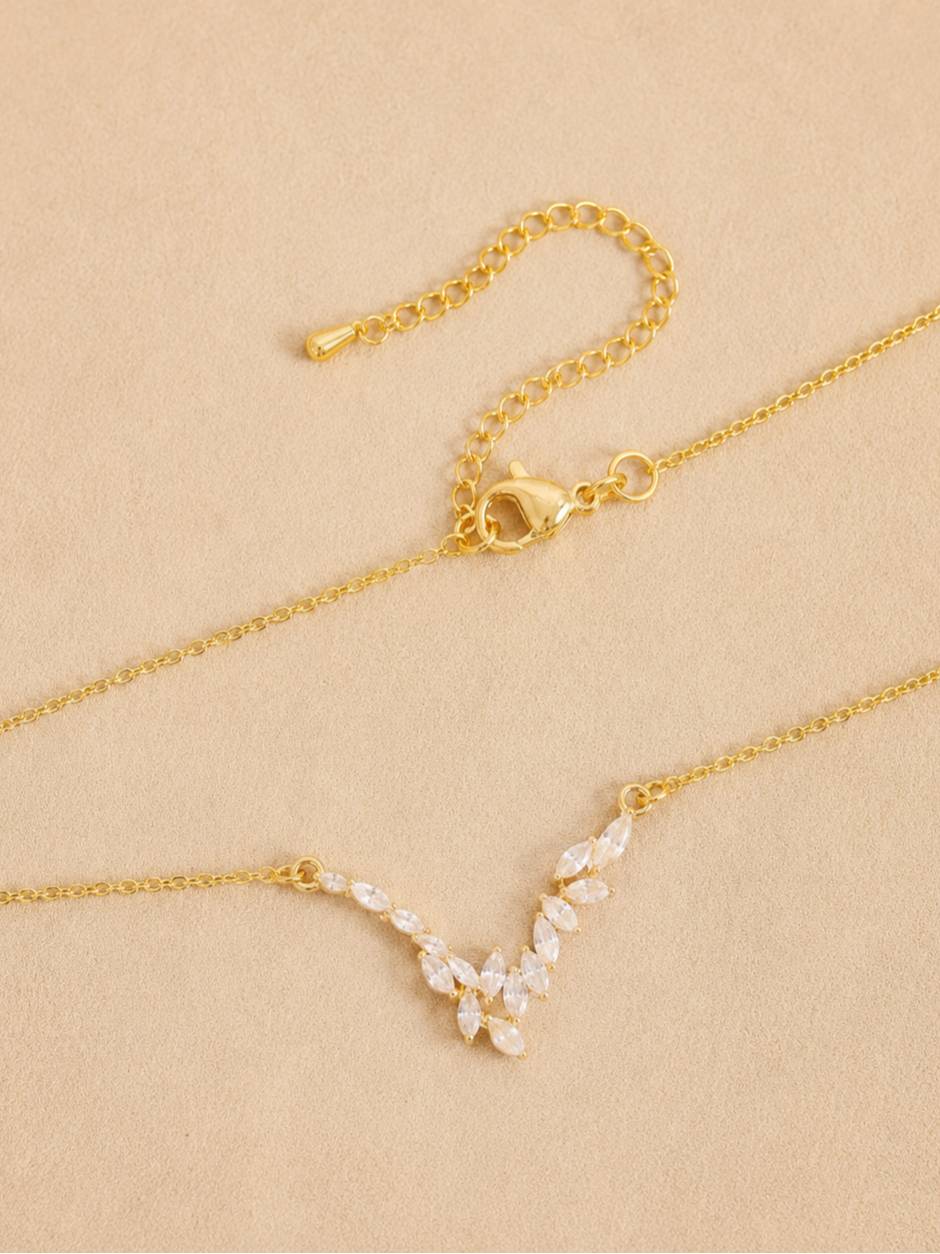 Flat lay of necklace showing lobster clasp, extender chain, and marquise CZ pendant from above