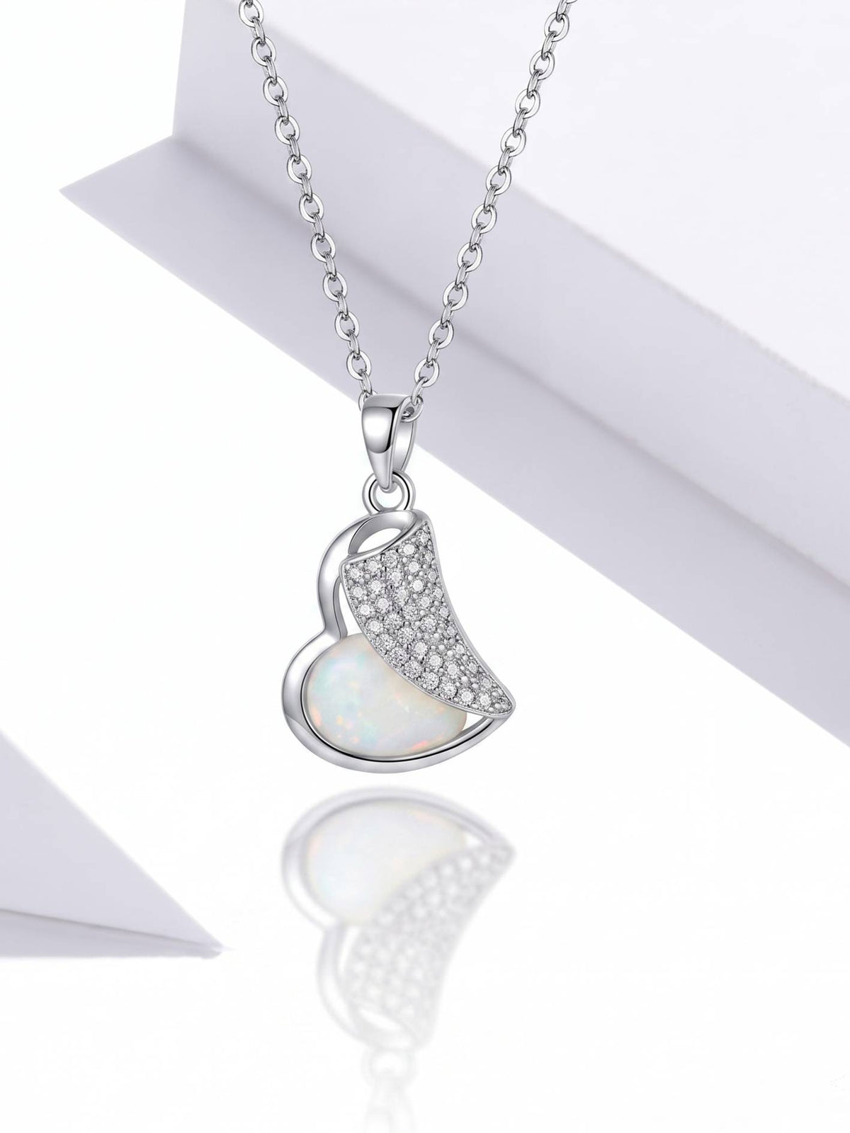 Front view of silver heart pendant showing opal-effect inlay and pavé cubic zirconia on white background