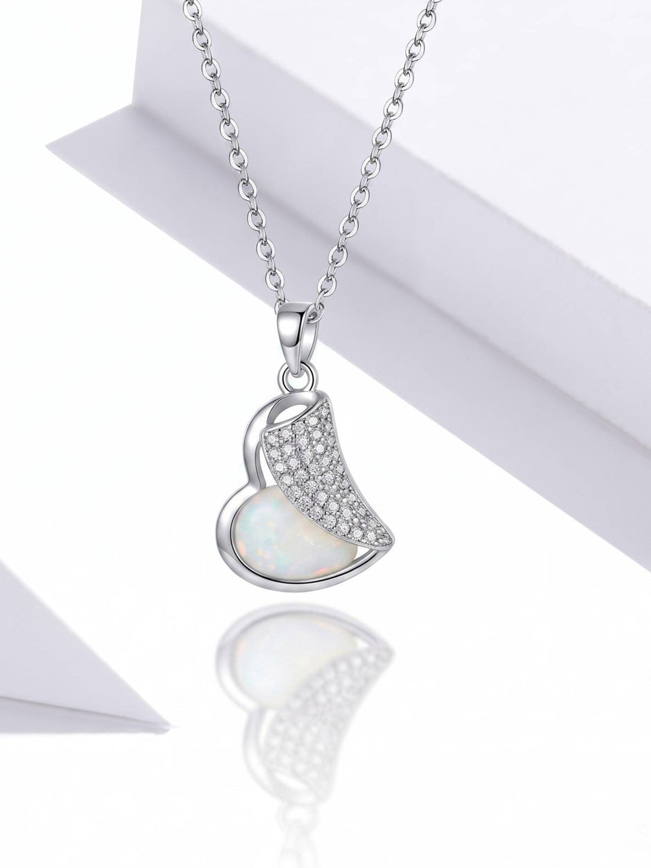 Front view of silver heart pendant showing opal-effect inlay and pavé cubic zirconia on white background