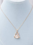 Rose gold heart pendant necklace displayed on a light blue velvet jewellery bust