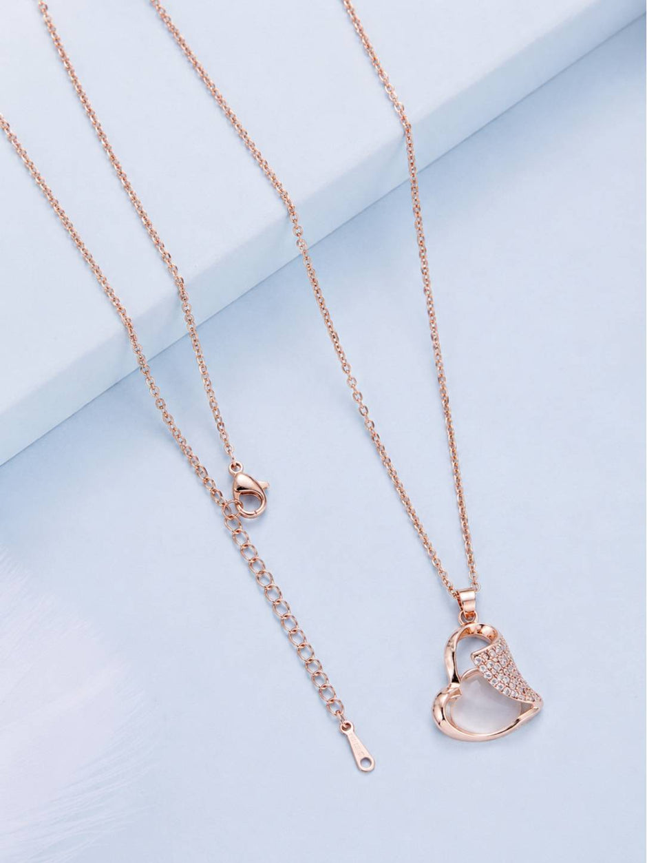 Back of rose gold necklace laid flat showing lobster clasp and extender chain links