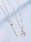 Back of rose gold necklace laid flat showing lobster clasp and extender chain links