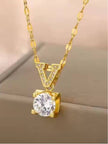 Gold V pendant necklace with pavé bail and solitaire stone shown against a beige fabric background