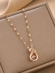 Rose gold swan pendant necklace displayed flat inside a beige jewellery box