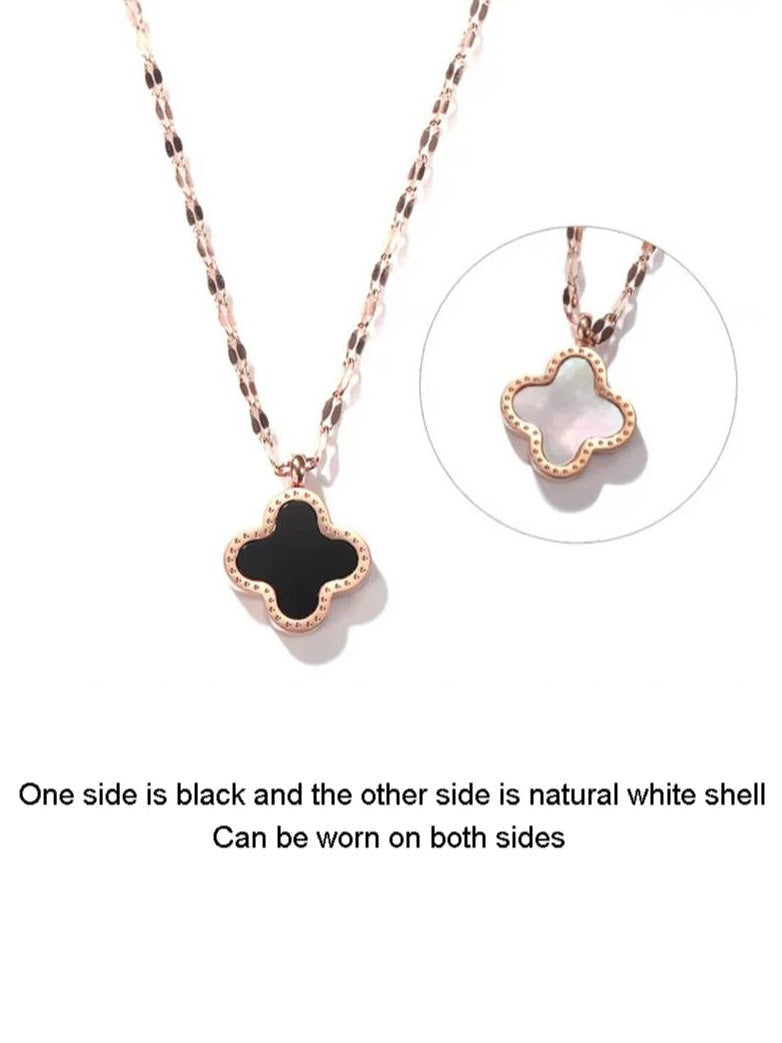 Side-by-side product shot showing black inlay front and natural white shell reverse of clover pendant