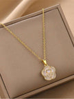 Gold-plated shell flower pendant necklace displayed flat inside a beige jewellery gift box