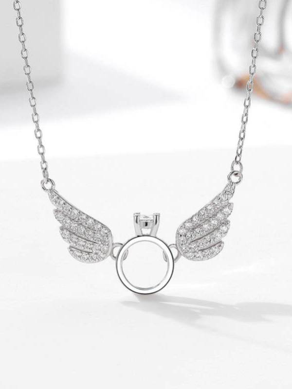 Front view of silver angel wings ring necklace with pavé crystal wings on white background