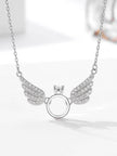 Front view of silver angel wings ring necklace with pavé crystal wings on white background