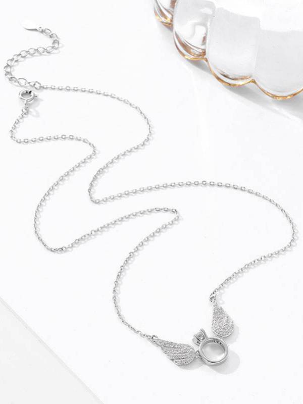 Full length view of silver cable chain angel wings necklace with lobster clasp extender