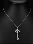 Silver-tone cubic zirconia key pendant necklace displayed on a black jewellery bust, front view