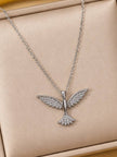 Silver CZ bird pendant necklace displayed flat on a beige jewellery box