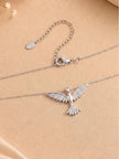 Reverse view of silver bird necklace showing lobster clasp and extender chain laid flat