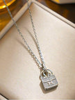 Silver zirconia bag pendant necklace displayed in a cream jewellery box close up
