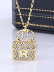 Close-up of gold-plated Constance-style bag pendant fully encrusted with round cubic zirconia stones