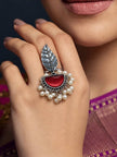 Oxidised silver leaf ring worn on finger against purple silk saree with pearl drops draping naturally