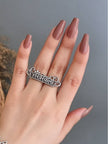 Nakhrewaali oxidised silver statement ring worn on middle finger of hand with mauve nail polish