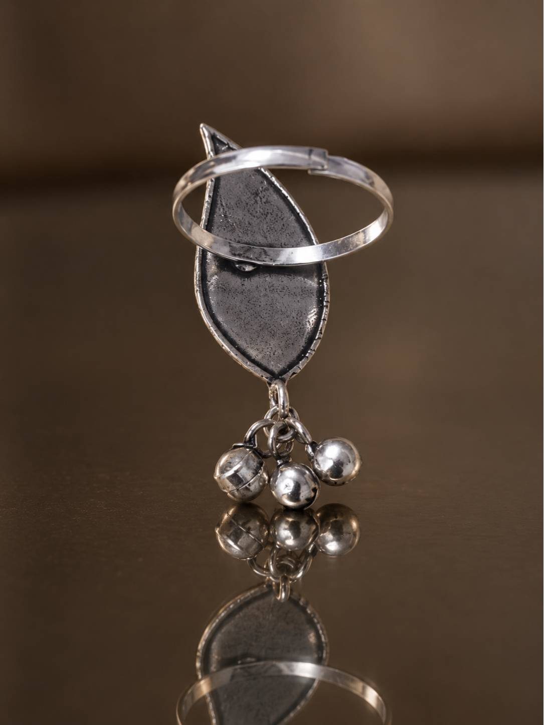 Back view of oxidised silver leaf ring showing open adjustable band and ghungroo charms