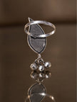 Back view of oxidised silver leaf ring showing open adjustable band and ghungroo charms