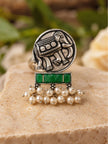 Front view of oxidised silver elephant coin ring with green baguette stones and white pearl drop dangles
