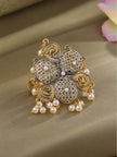 Oxidised silver floral ring with gold paisley motifs, honeycomb jali dome petals and hanging pearl drops on a gold fabric surface