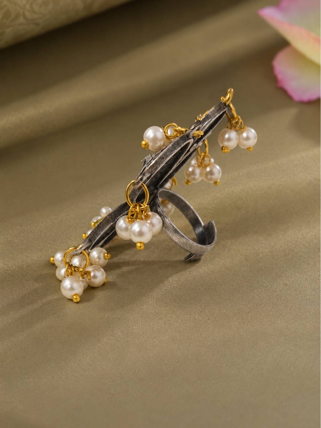 Side profile of oxidised silver floral ring showing pearl drop clusters and gold-tone jump rings on adjustable band