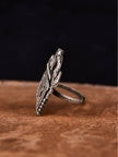 Side profile of oxidised silver Radha ring showing depth of carved Devanagari lettering and slim band