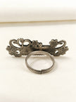 Back view of oxidised silver name ring showing adjustable open-back band and reverse of ornate face