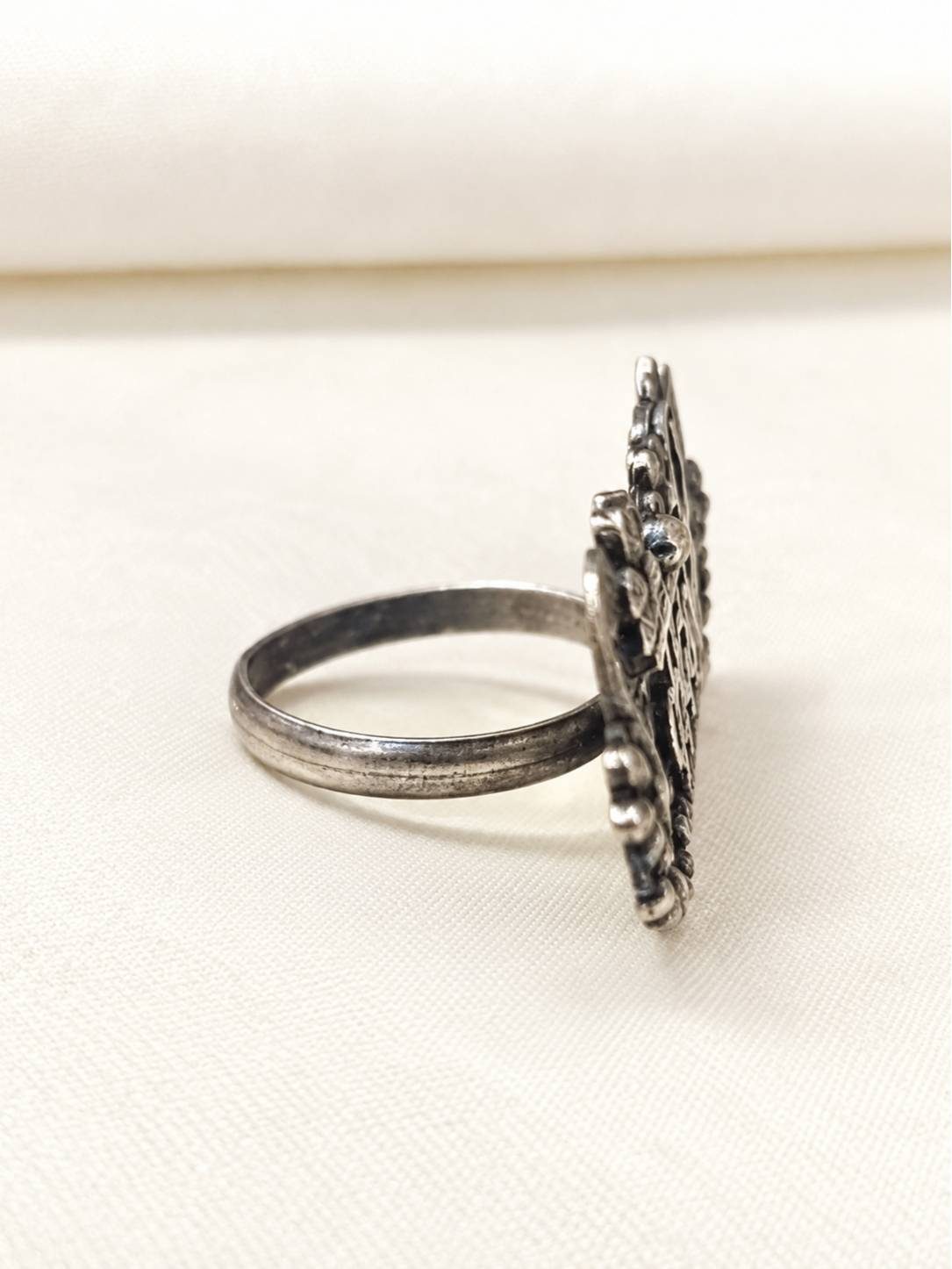 Side profile of oxidised silver Kadambari ring showing height of wide statement bezel and band
