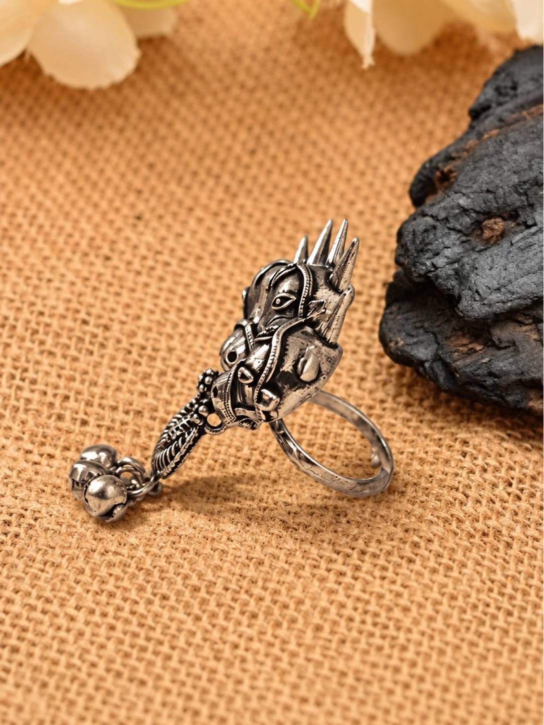 Side profile of oxidised silver horse head ring showing curved drop detail and open adjustable band
