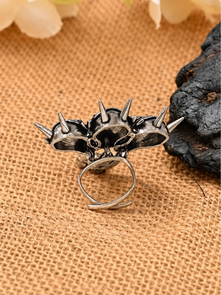 Back view of triple horse head ring revealing hollow spike crowns and open-shank adjustable band