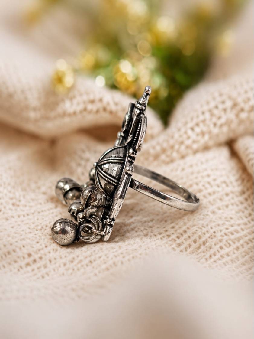 Side profile of oxidised silver statement ring revealing height of the disc motif and hanging silver ghungroo bells
