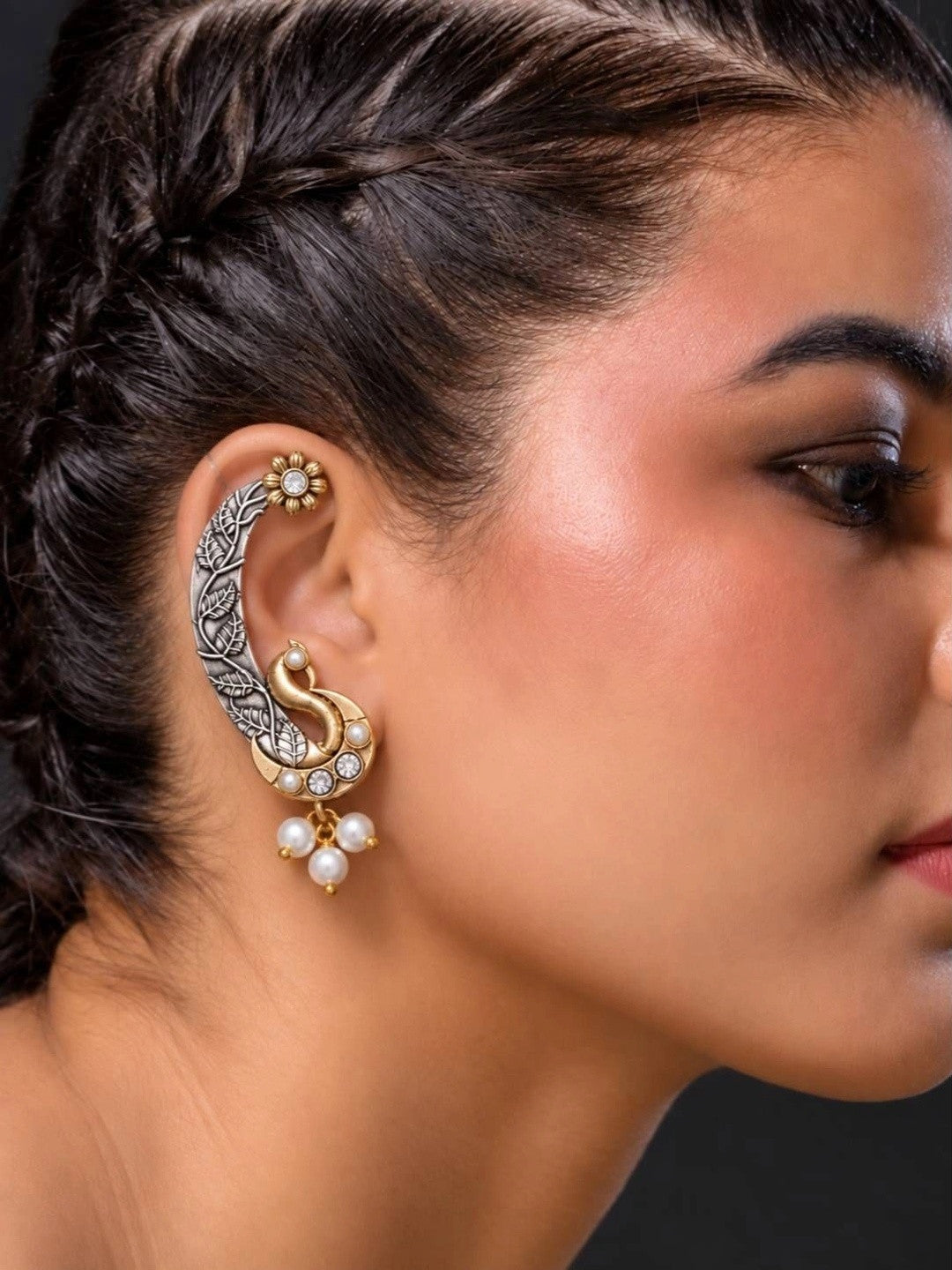 Model wearing oxidised peacock ear cuff on right ear showing full cartilage wrap and dangling pearls
