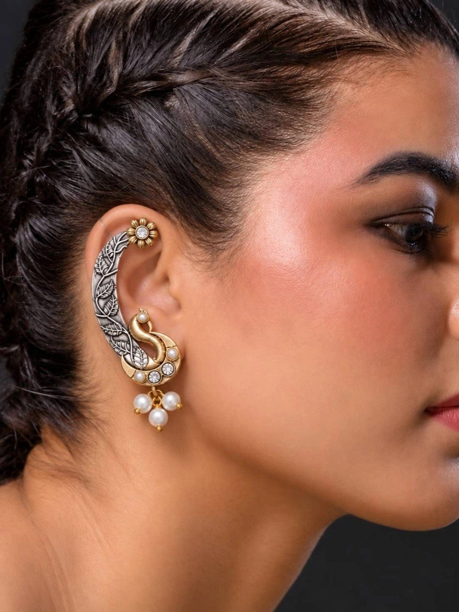 Model wearing oxidised peacock ear cuff on right ear showing full cartilage wrap and dangling pearls