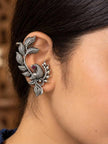 Oxidised silver bird ear cuff earring worn on a woman's left ear showing full fit