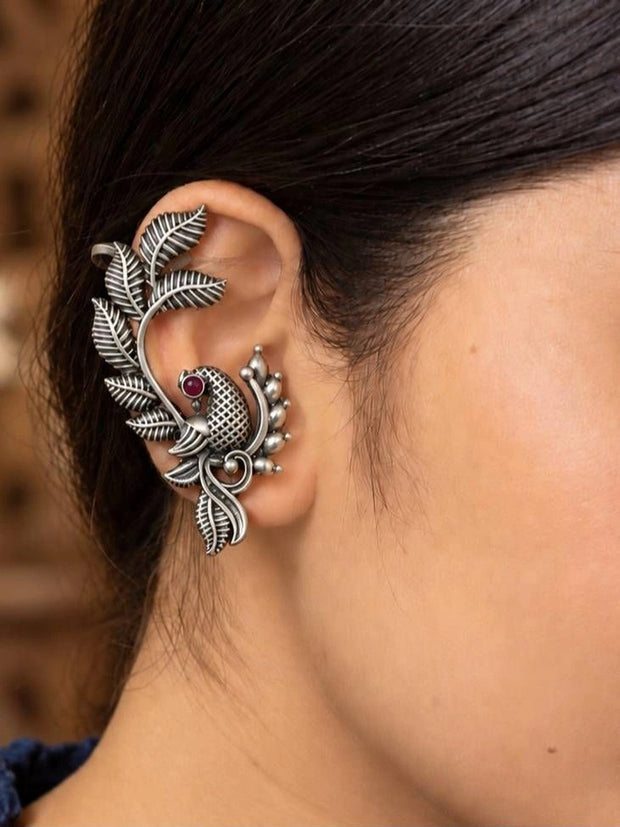 Oxidised silver bird ear cuff earring worn on a woman's left ear showing full fit