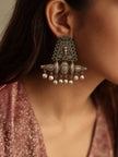 Woman wearing oxidised silver green stone chandbali earring with ghungroo drops paired with pink printed ethnic top