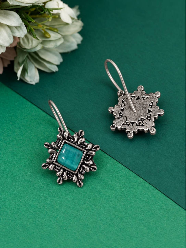 Front and back view of oxidised silver square earrings showing detailed floral metalwork and plain reverse side