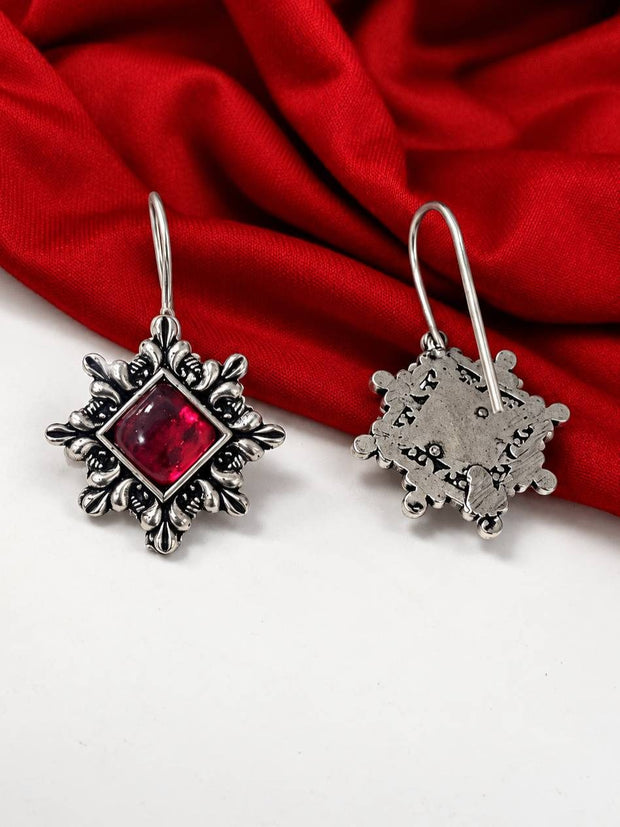 Front and back view of oxidised silver hook earrings showing intricate floral detailing and reverse metalwork