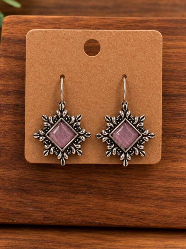 Pair of oxidised silver square drop earrings with lavender stone on kraft display card