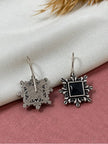 Front and back view of oxidised silver square earrings showing detailed reverse metalwork on pink background
